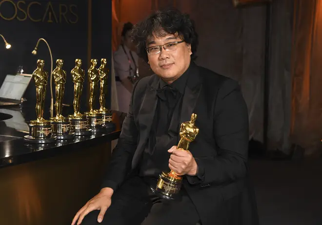 Bong Joon-ho celebrates after winning Best Director and Best Picture for Parasite