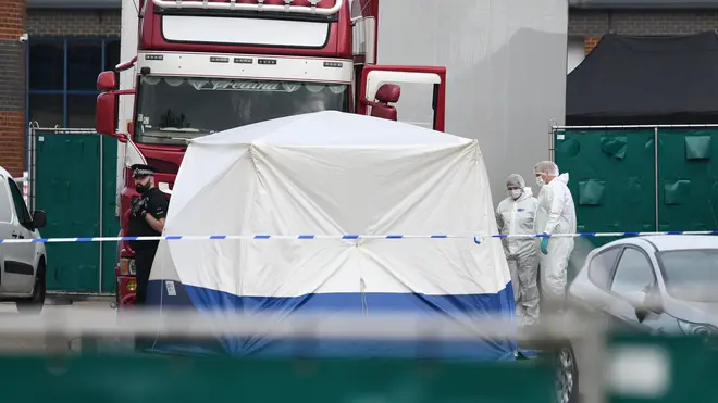 Police and forensic officers investigate the site where 39 bodies were discovered in the back of a lorry on October 23, 2019