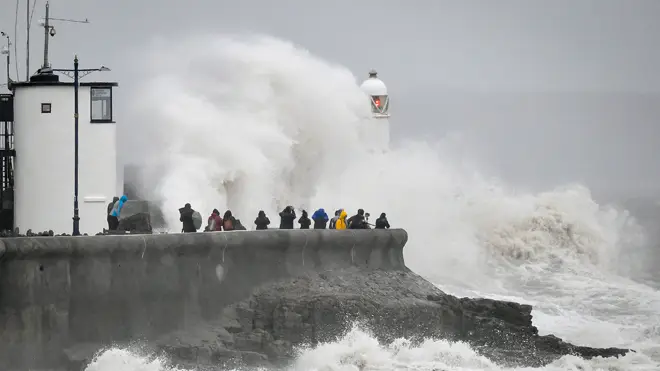 Rough seas pound against the harbour wall at Porthcawl, Wales