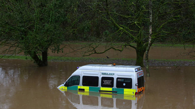 An Ambulance stands submerged in flood water after the River Taff burst its banks in Nantgarw, south of Ponypridd in south Wales