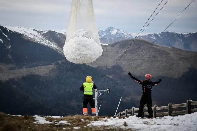 Workers were seen delivering snow to the slopes