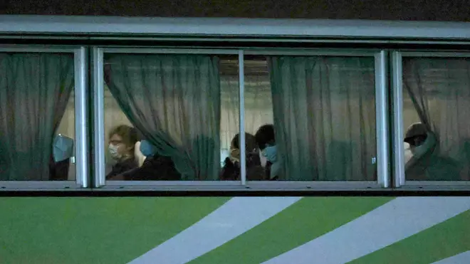 A bus carrying British  passengers from the quarantined Diamond Princess cruise ship leaves Daikoku Pier