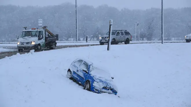 A car that has come off the road in snow in Bedale, North Yorkshire