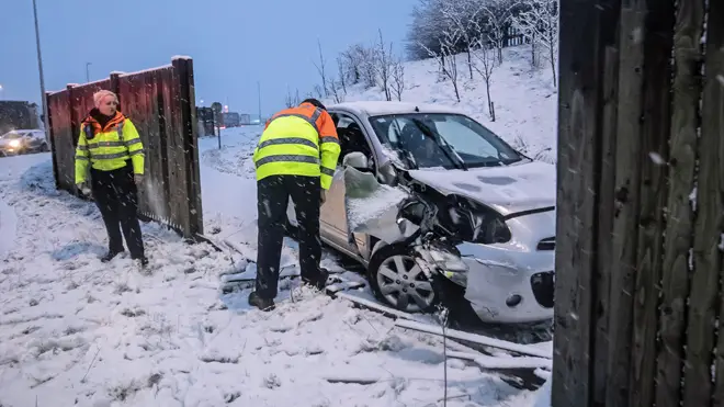 A traffic officer talks to the driver of a crashed car near Leeming Bar in North Yorkshire
