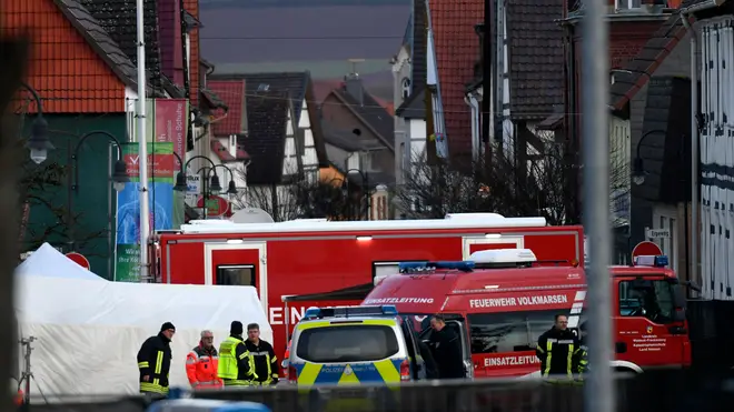 Vehicles of the police and the fire brigades stand at the site where a man who drove into a carnival procession