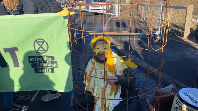 Several of the caged protesters are dressed as canaries