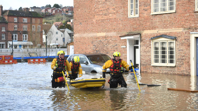 Fire and Rescue officers use an inflatable raft in Bewdley, Worcestershire