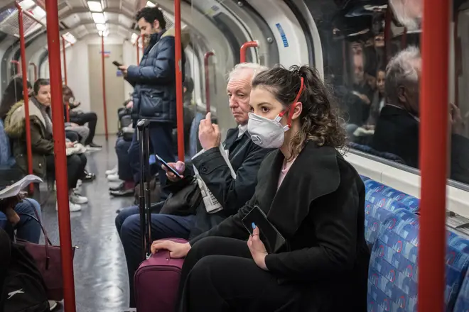 A woman wearing a facemask to ride the tube