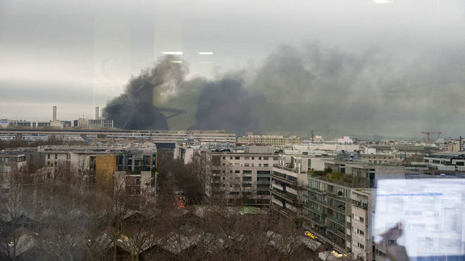 Smoke can be seen rising from the blaze over the city