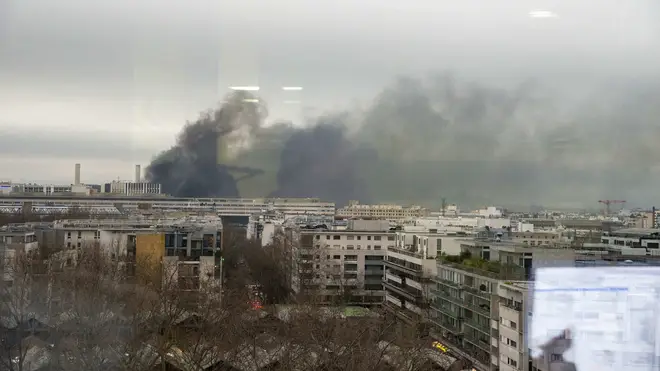 Smoke can be seen rising from the blaze over the city