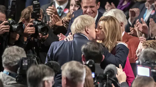 Boris Johnson and Carrie Symonds share a kiss after the Tory election victory