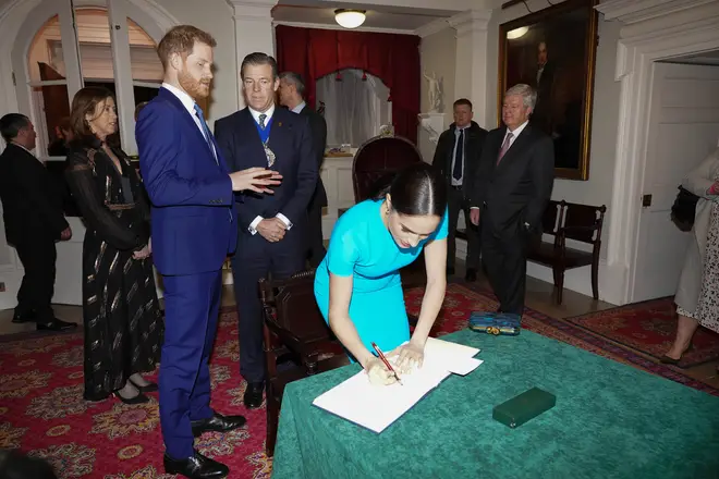 The Duke and Duchess sign a book at the event