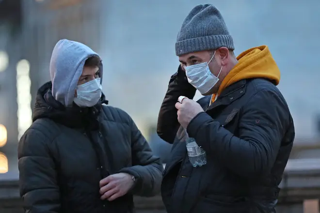 People wearing facemasks in Trafalgar Square over coronavirus fears