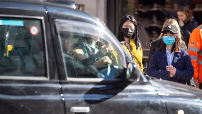 Two women in face masks on the streets of London
