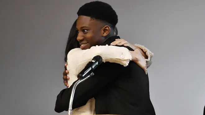 Aker Okoye, 16, hugs Meghan Markle at the school in east London