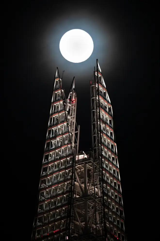 A super moon rises above the Shard