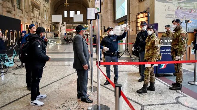 Passengers are checked as they leave Milan central station