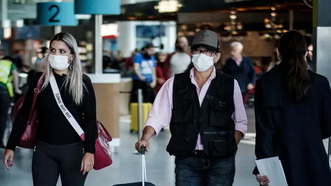 Tourists arriving at Lisbon airport with masks to protect themselves from COVID 19