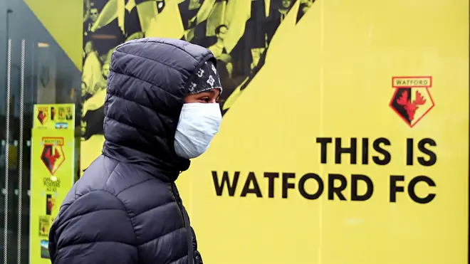 A youth wears a protective face mask on the weekend all Premier League matches are postponed