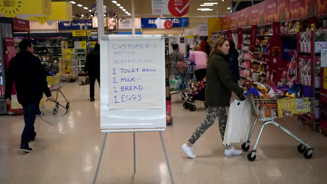 A board displays shopping restrictions at Tescos supermarket on March 19, 2020 in Warrington