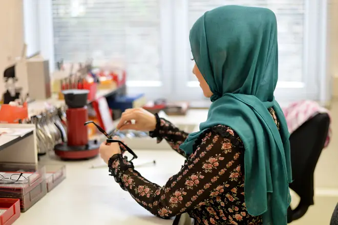 A woman wearing a hijab at work