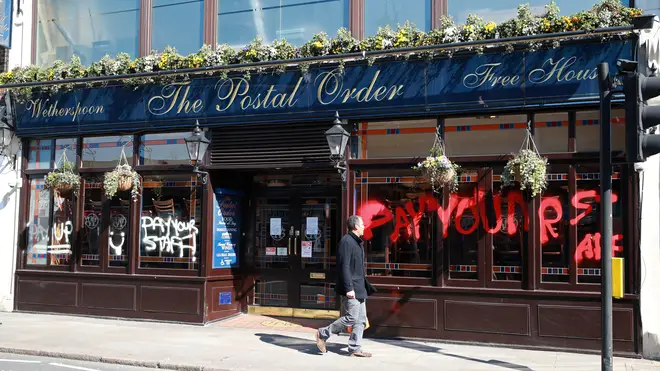 Someone painted "Pay Your Staff" on the front of one of the pubs venues