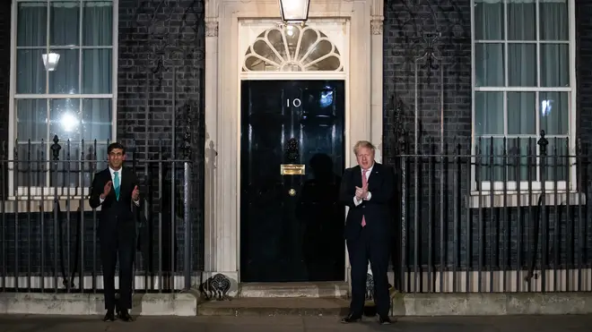 Prime Minister Boris Johnson (right) and Chancellor Rishi Sunak outside 10 Downing Street, London, joining in with a national applause for the NHS