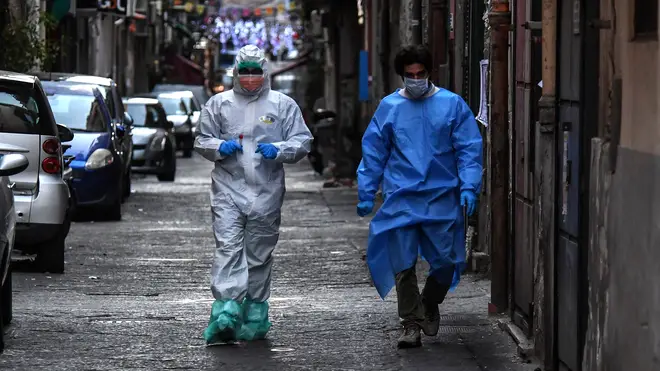 Doctors wear protective clothing as they carry out checks on citizens in Naples, Italy