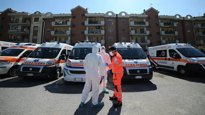Red Cross staff wearing a protective containment suit sanitizes an ambulance that transported a Covid 19 patient in Baronissi, Italy