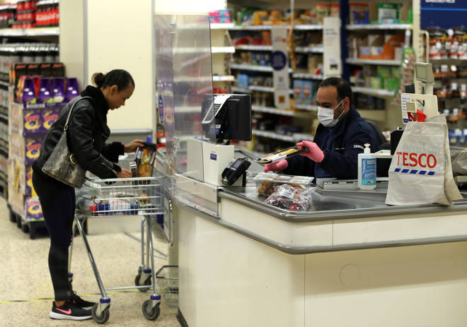 A Tesco worker in a protective mask
