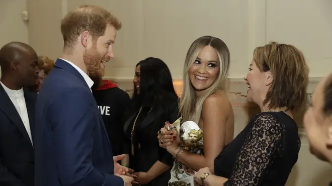 The pair pictured meeting Prince Harry together