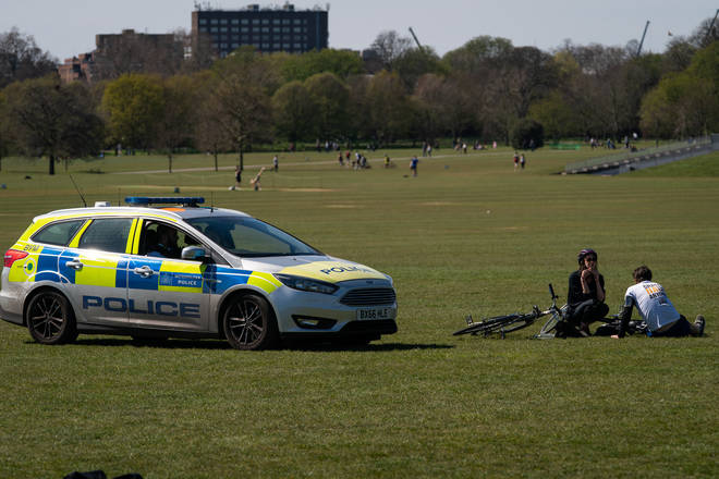 Police moving people along who are sunbathing in Regent's Park