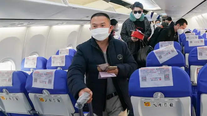 Passengers board flight MU2527 out of Wuhan
