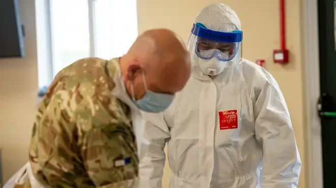 Members of the British Army learn how to apply PPE to support the Welsh Ambulance Service
