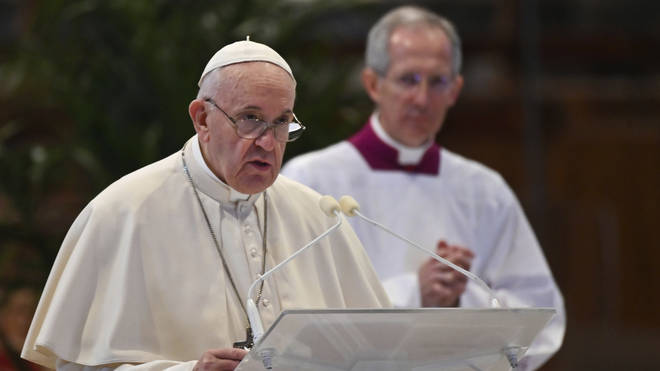 Pope Francis delivers his message during Easter Sunday Mass inside an empty St. Peter's Basilica
