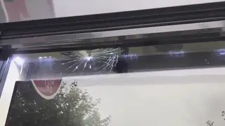 The bullet-hole in the window of Chicken Cottage