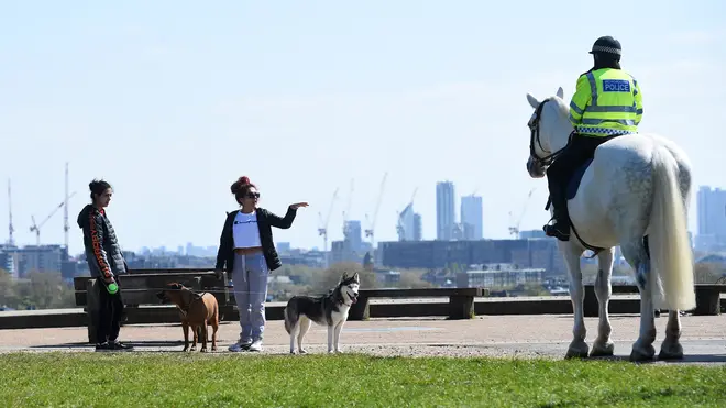 File photo: Mounted police officers speak to people on Primrose Hill, London, as the UK continues in lockdown