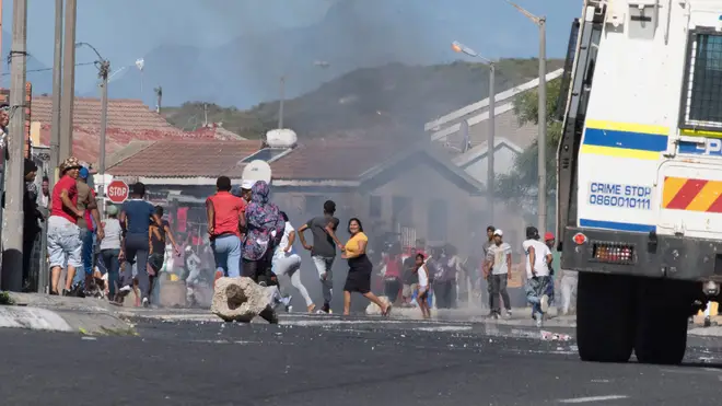 Residents of an impoverished suburb in Mitchells Plain, near Cape Town, clashed with authorities after some people did not receive food parcels