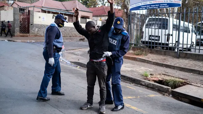 Police search one man in Johannesburg amid a strict lockdown