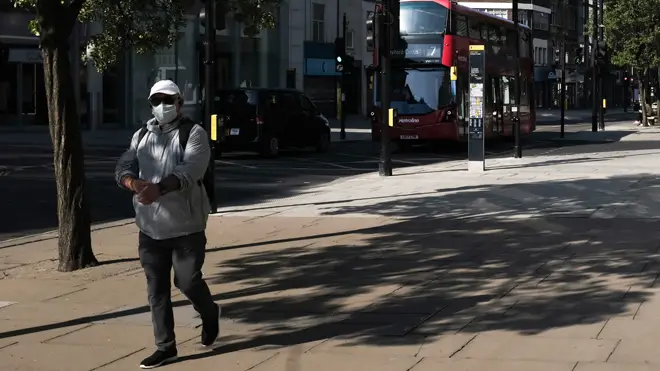 A man walks down empty Oxford Street in central London during the coronavirus lockdown