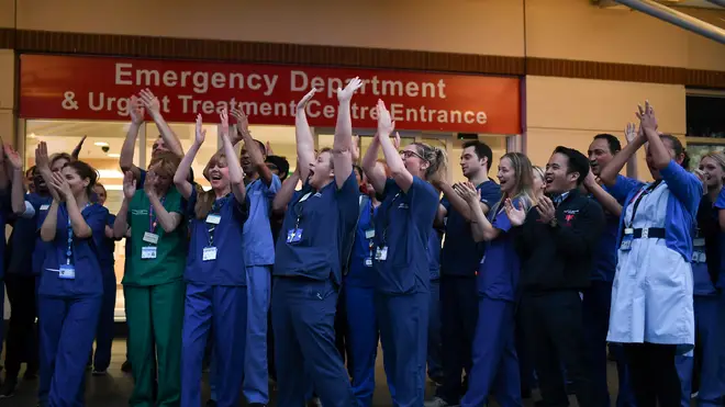 File photo: NHS staff applaud outside the Chelsea and Westminster Hospital in London during the weekly "Clap for our Carers"