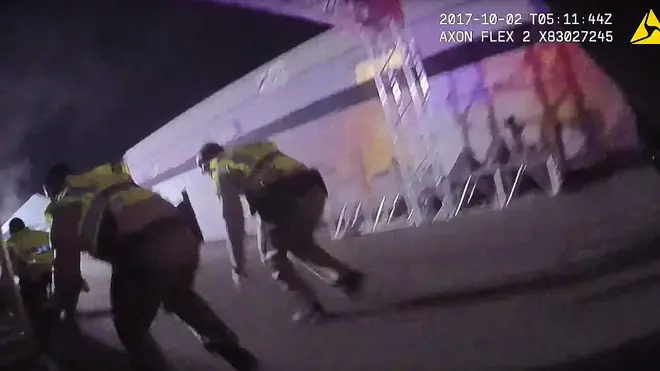 Police are seen crouching to avoid the Las Vegas gunfire