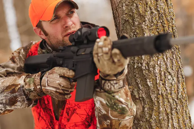 A deer hunter aiming an AR-15 in Minnesota, USA