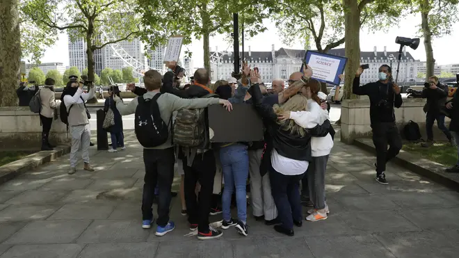 Protesters hugged in defiance of coronavirus lockdown laws