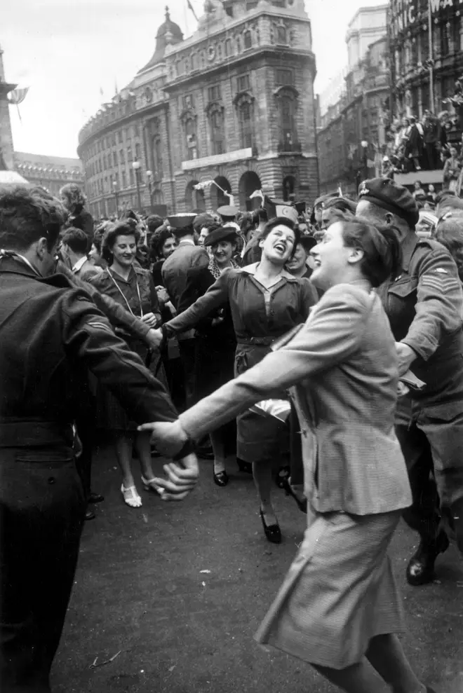 Jubilant Londoners dancing in Piccadilly Circus on VE Day