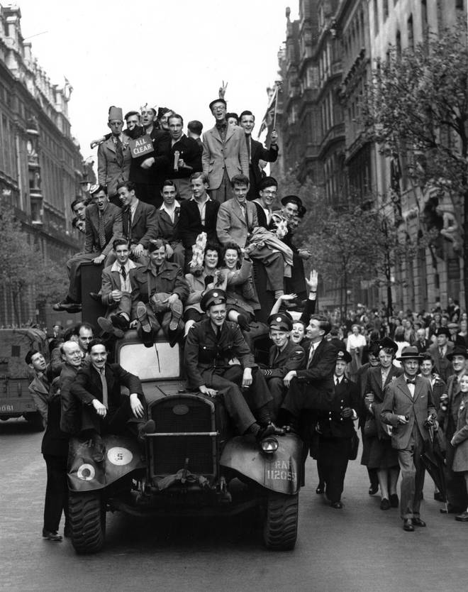 VE Day revellers hitching a ride on a lorry in London