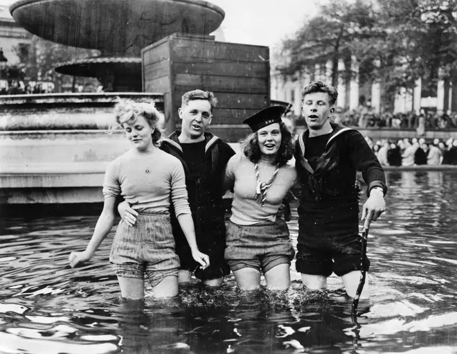 Young adults in Trafalgar cooled off during the celebrations by wading in the fountains