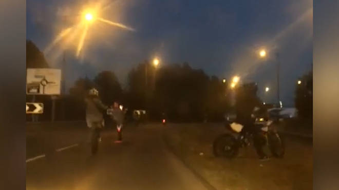 Motorcyclists pull wheelies