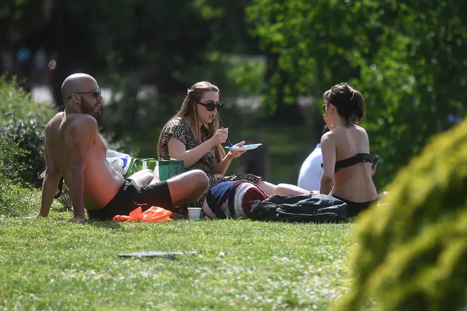 Friends and family can now meet under new coronavirus lockdown rulessit in the sun in Battersea Park