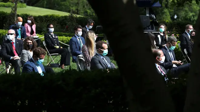 Other attendees wore masks to the White House press conference